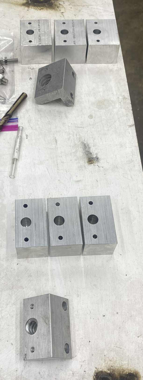 Machined aluminum blocks with holes and threads